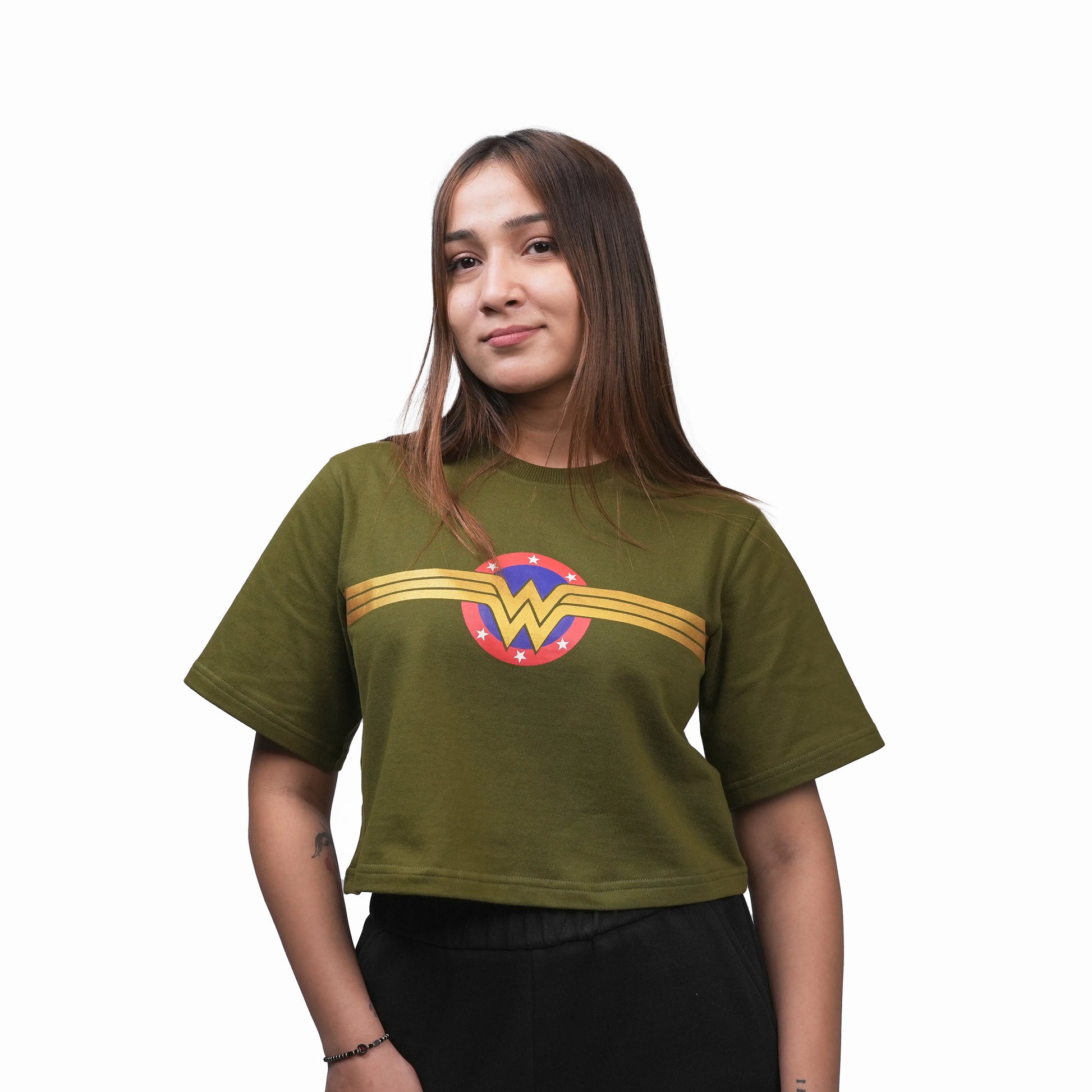 Person wearing a green t-shirt with a superhero logo on a white background