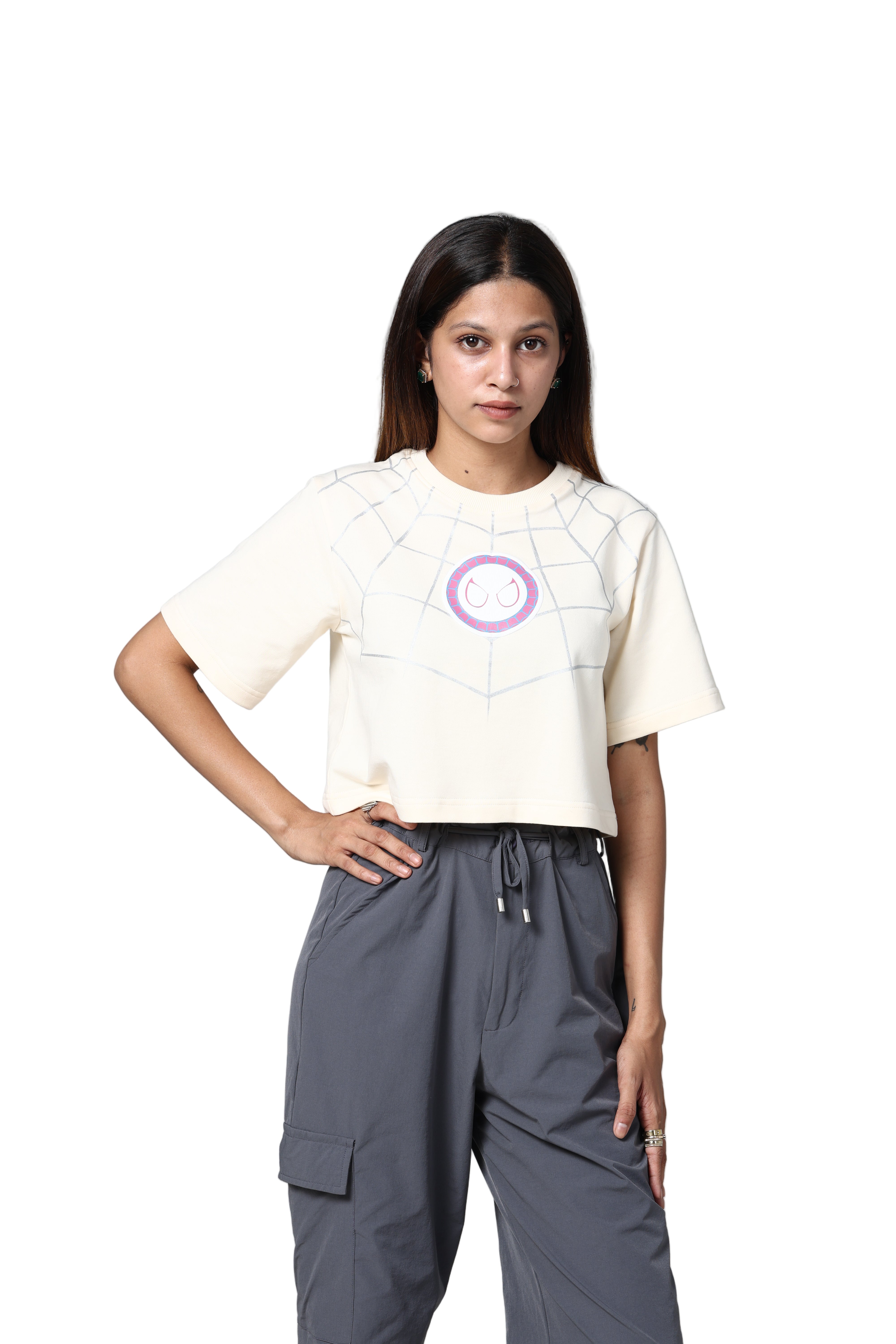 Person wearing a white t-shirt with a logo and gray pants on a light gray background